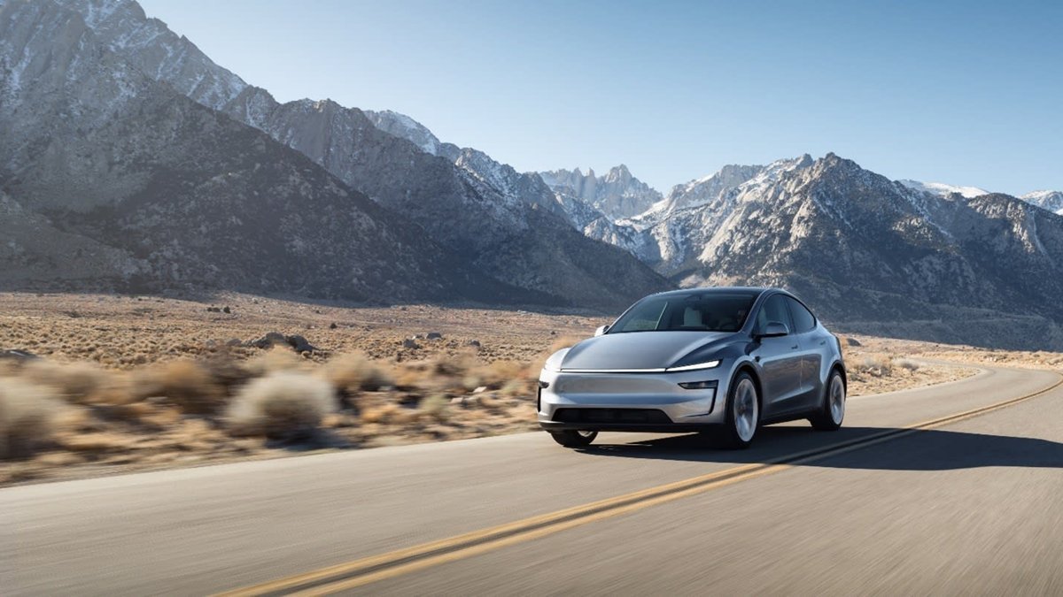 New Tesla Model Y Juniper driving on a mountain road